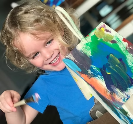 Child painting during a session